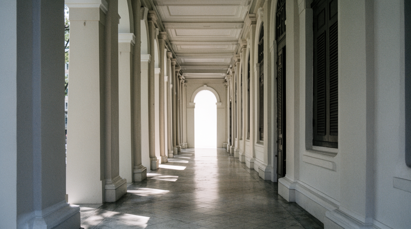 Colonnade of pale plaster columns in deep shade