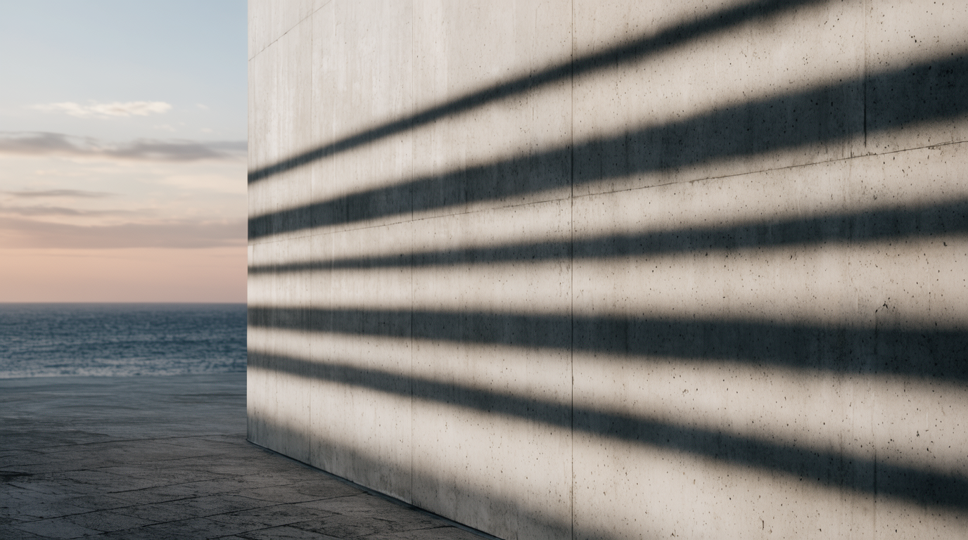 Pale concrete facade edge against a soft dusk gradient sky